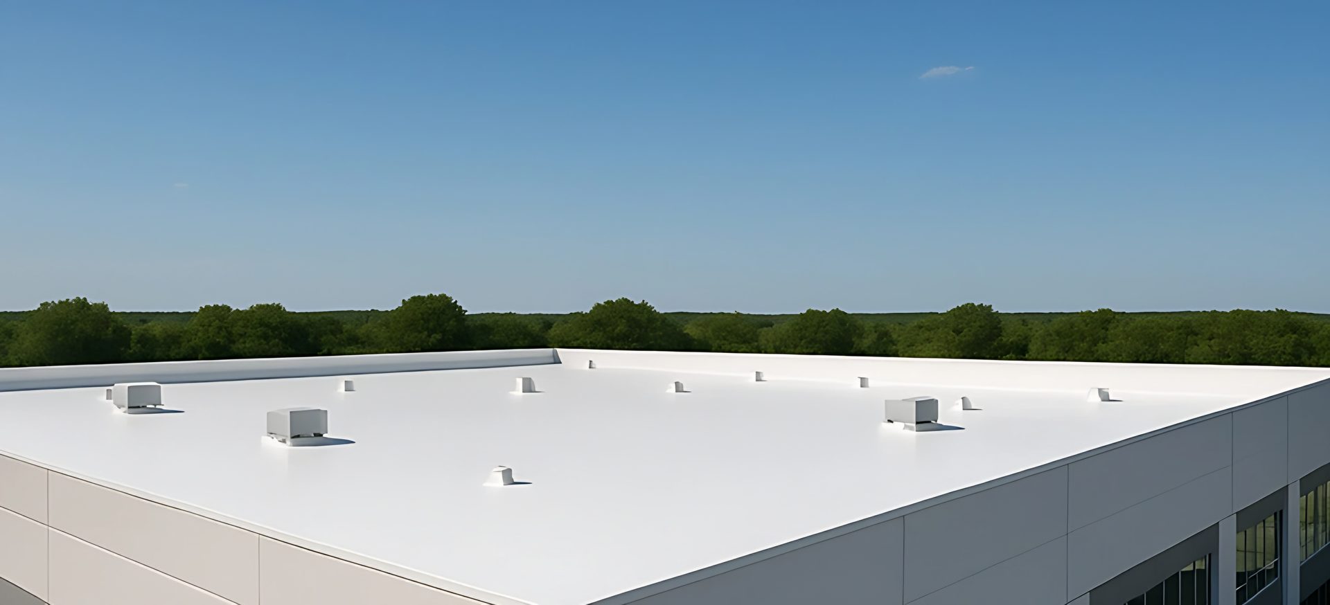 White commercial roof under a clear sky (illustrative image)
